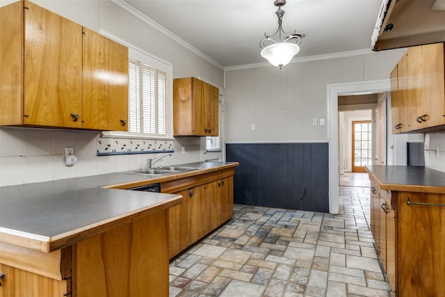 kitchen featuring brown cabinetry and pendant lighting