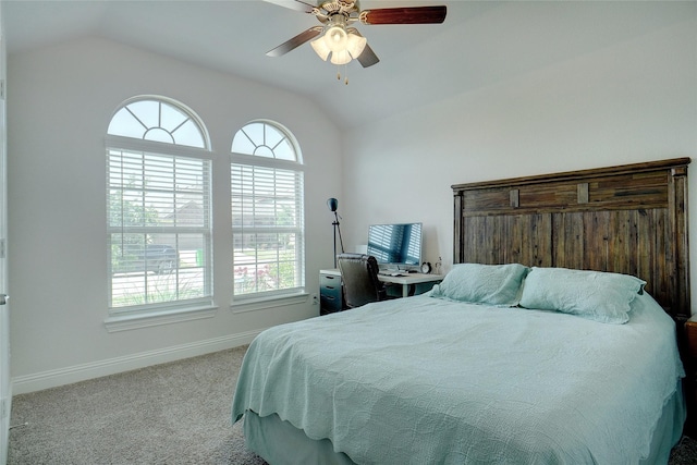 bedroom featuring lofted ceiling, ceiling fan, baseboards, and light colored carpet