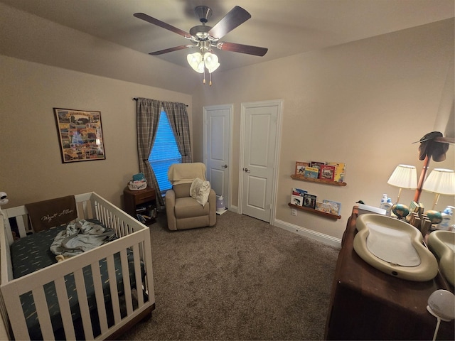 bedroom featuring dark colored carpet, ceiling fan, and baseboards