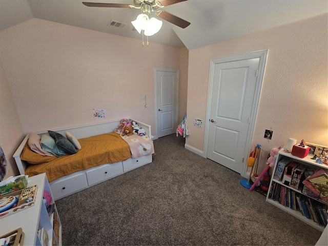 bedroom featuring lofted ceiling, dark colored carpet, ceiling fan, and visible vents