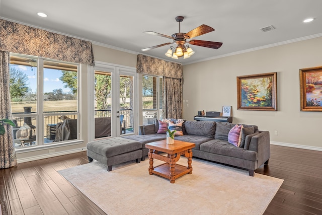 living room with visible vents, ornamental molding, hardwood / wood-style floors, and baseboards