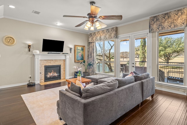 living room featuring ornamental molding, dark wood-type flooring, and visible vents