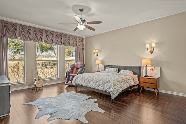 bedroom featuring a ceiling fan, dark wood-style flooring, crown molding, and baseboards