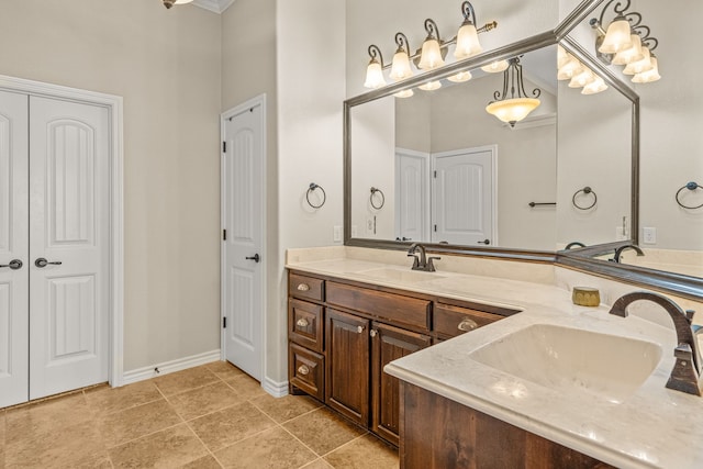 bathroom featuring a closet, a sink, baseboards, and double vanity