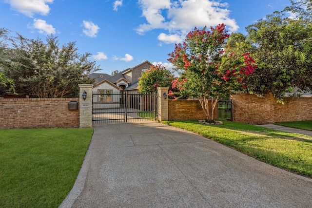 view of gate featuring a fenced front yard and a yard