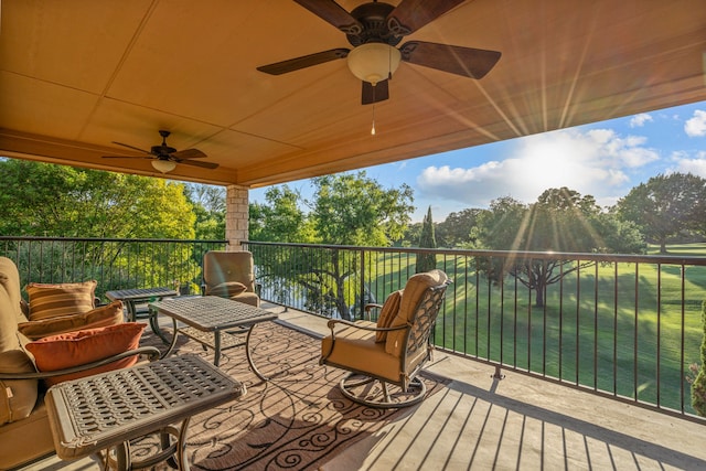 wooden terrace featuring a water view and a ceiling fan