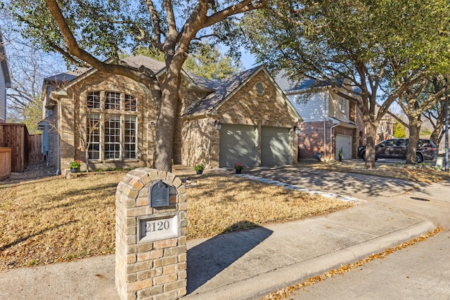 view of front of house featuring a garage, driveway, and brick siding