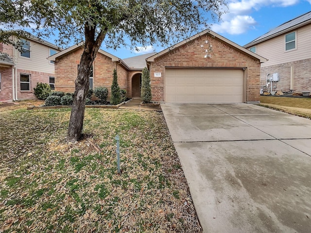 view of front facade featuring driveway, brick siding, an attached garage, and a front yard