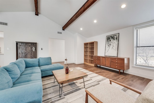 living area with visible vents, baseboards, lofted ceiling with beams, light wood-type flooring, and recessed lighting