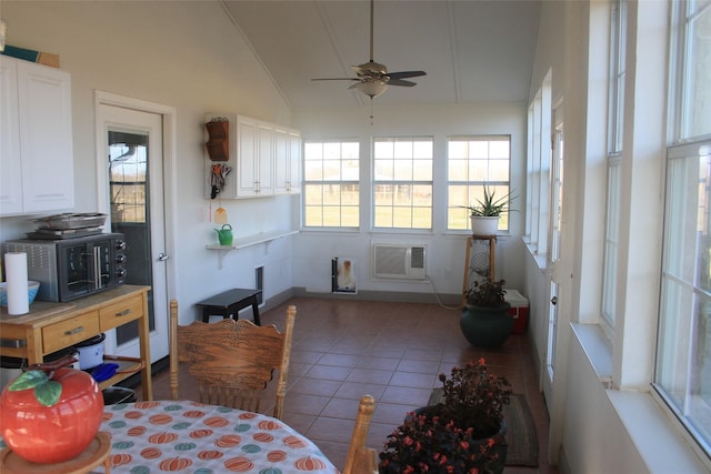 sunroom / solarium with a wall unit AC, ceiling fan, and vaulted ceiling