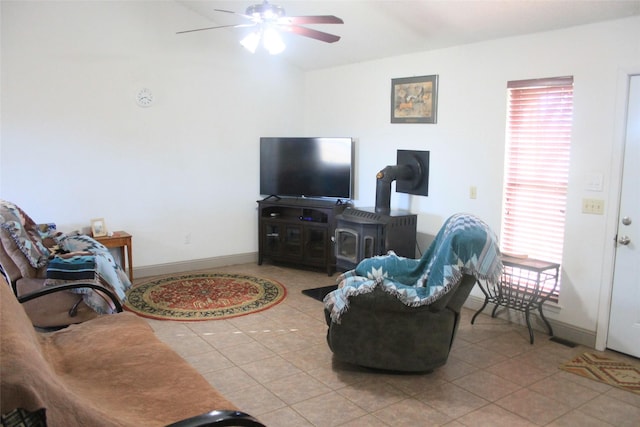 living room featuring light tile patterned floors, ceiling fan, and baseboards