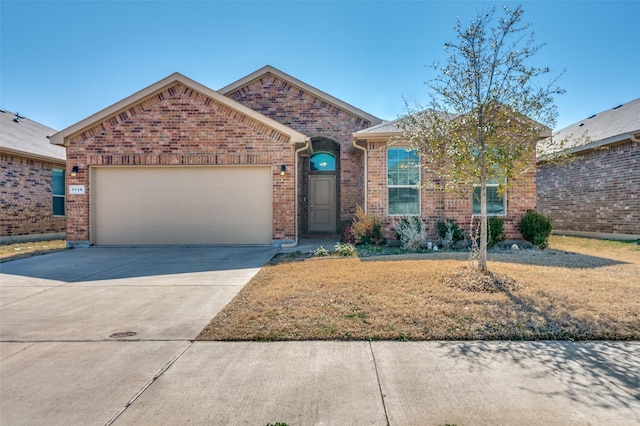 ranch-style home featuring a garage, driveway, and brick siding