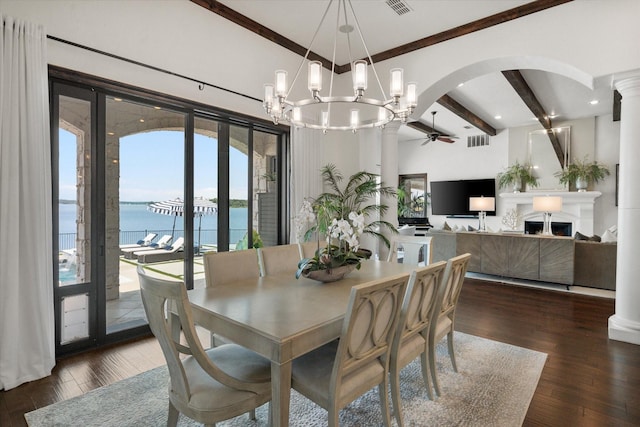 dining space with dark wood-style flooring, a water view, visible vents, and beam ceiling