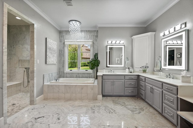 full bath with double vanity, visible vents, ornamental molding, a garden tub, and a sink