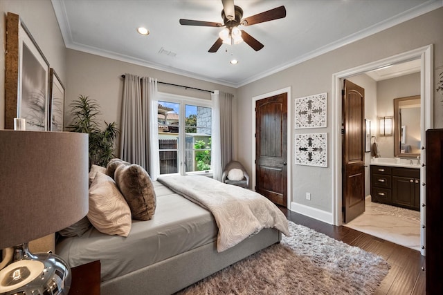 bedroom featuring visible vents, crown molding, baseboards, and wood finished floors