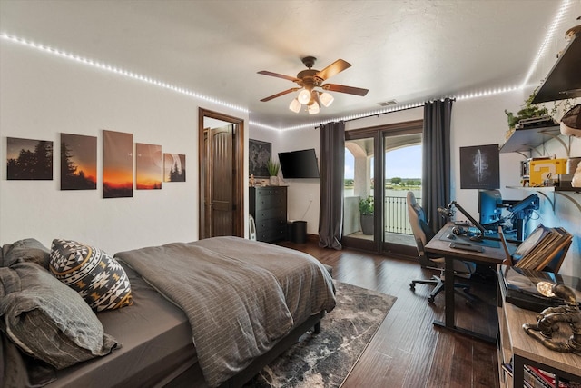 bedroom featuring dark wood-type flooring, a ceiling fan, and access to exterior