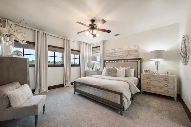 bedroom featuring carpet floors, visible vents, baseboards, and a ceiling fan