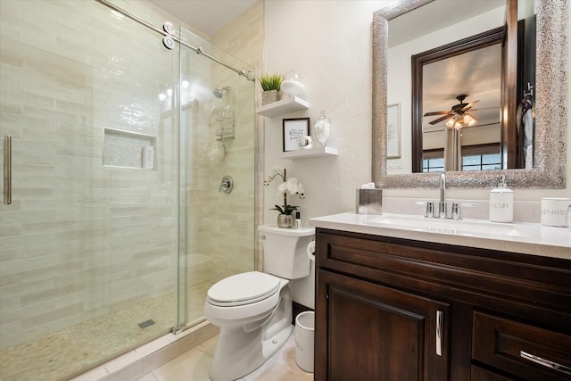 full bathroom featuring toilet, a shower stall, ceiling fan, and vanity