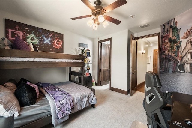 bedroom featuring light colored carpet, visible vents, attic access, ceiling fan, and baseboards