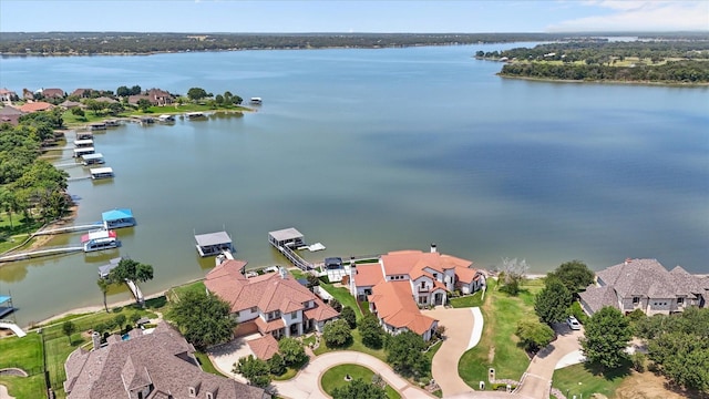 drone / aerial view featuring a water view and a residential view