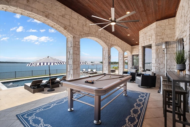 view of patio featuring a water view, outdoor lounge area, and a ceiling fan