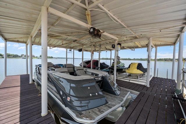 dock area with a water view and boat lift