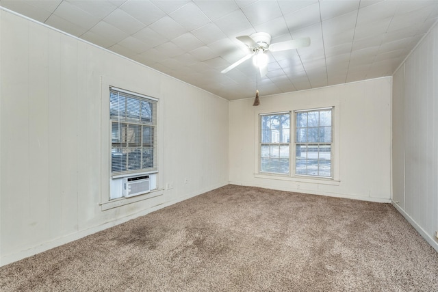 carpeted spare room featuring ceiling fan and cooling unit