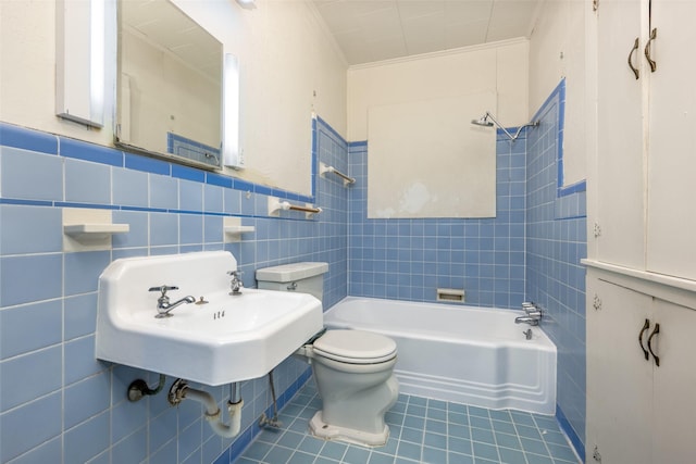 bathroom featuring crown molding, tile walls, toilet, tub / shower combination, and tile patterned flooring