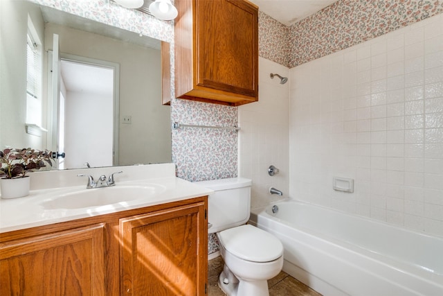 bathroom featuring toilet, wallpapered walls, washtub / shower combination, and vanity