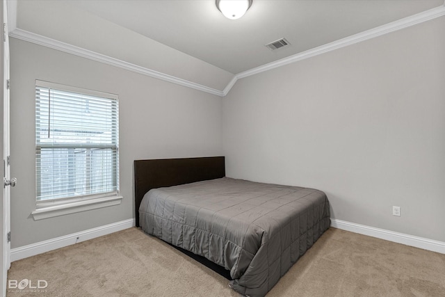 bedroom featuring light carpet, visible vents, baseboards, vaulted ceiling, and crown molding