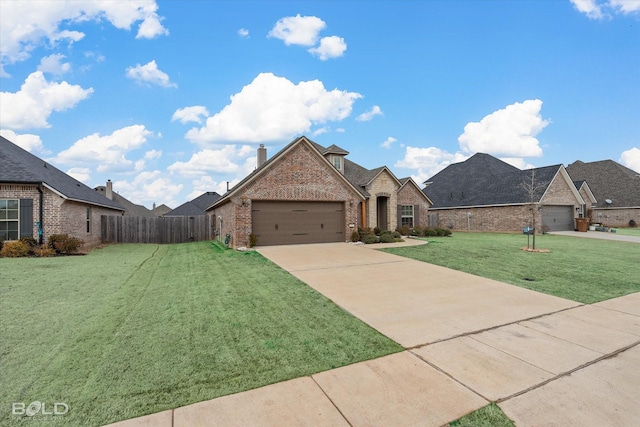 french provincial home with a garage, brick siding, fence, driveway, and a front yard