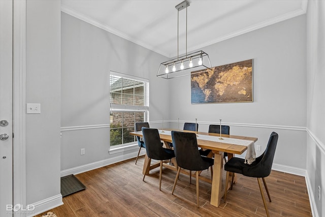 dining area with ornamental molding, baseboards, and wood finished floors