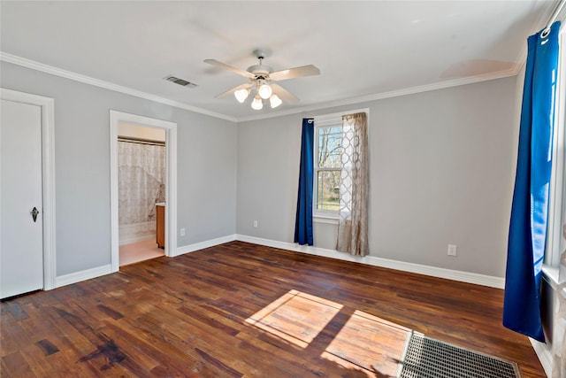 unfurnished bedroom with ornamental molding, visible vents, and dark wood finished floors