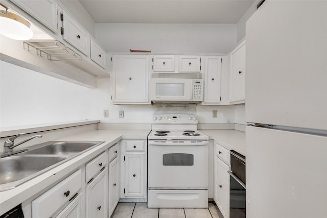 kitchen featuring white appliances, white cabinetry, and light countertops