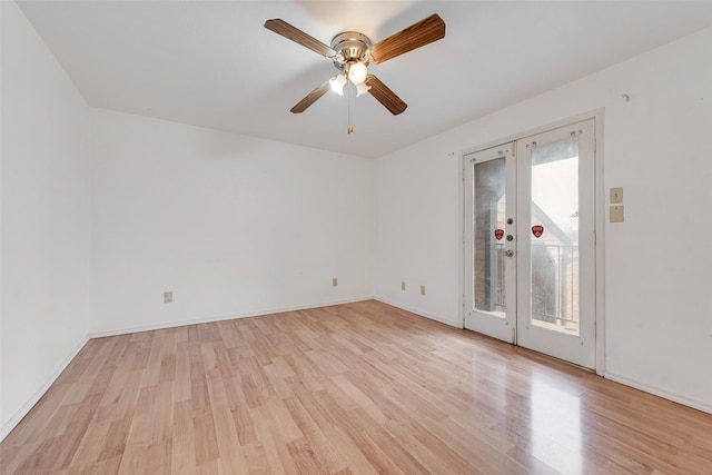 spare room featuring ceiling fan, french doors, light wood finished floors, and baseboards