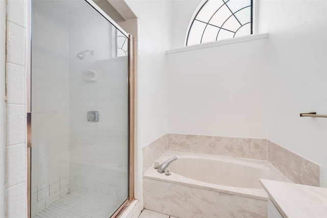 full bath with a shower stall, vanity, and a bath