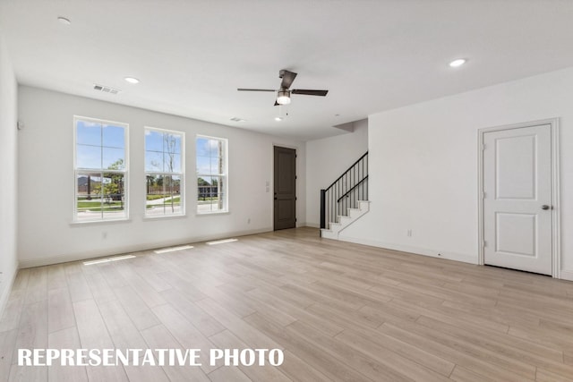 unfurnished living room with light wood-type flooring, ceiling fan, stairway, and recessed lighting