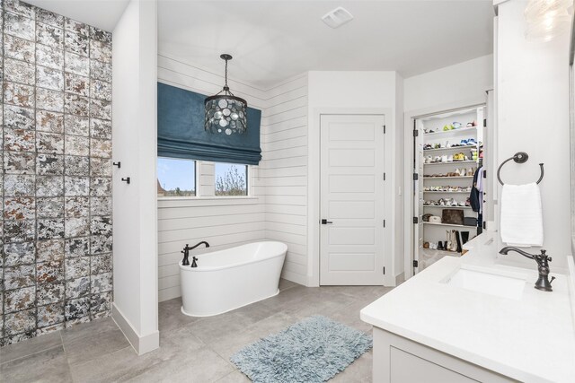 3200 W Fm 455, Celina, TX 75009 - bathroom featuring a walk in closet, a soaking tub, visible vents, and vanity