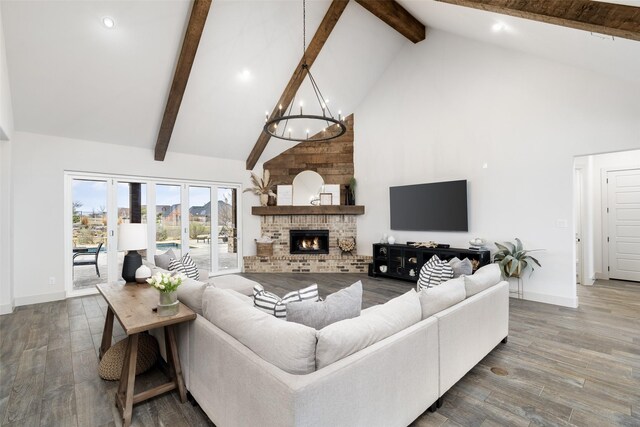 3200 W Fm 455, Celina, TX 75009 - living room featuring high vaulted ceiling, a fireplace, wood finished floors, and an inviting chandelier
