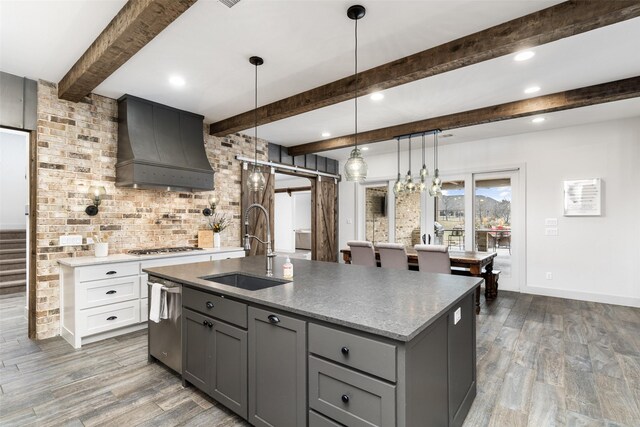 3200 W Fm 455, Celina, TX 75009 - kitchen with a center island with sink, a barn door, white cabinets, a sink, and premium range hood