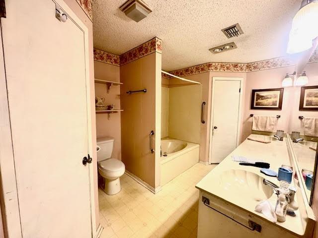 23319 Penninsula Pt, Frankston, TX 75763 - bathroom with tile patterned floors, shower / bathtub combination, toilet, a textured ceiling, and double vanity