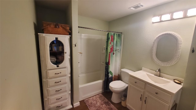 bathroom with visible vents, wood finished floors, vanity, toilet, and shower / tub combo with curtain