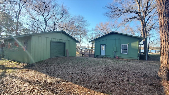 view of outbuilding featuring entry steps, driveway, and an outbuilding