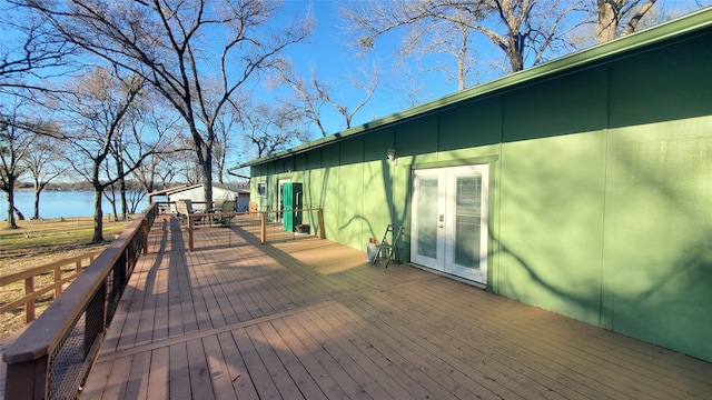 deck with a water view and french doors