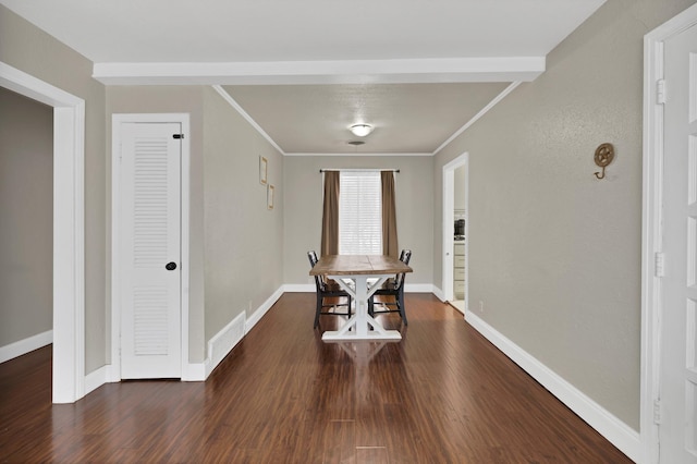 dining area with ornamental molding, dark wood-style flooring, and baseboards