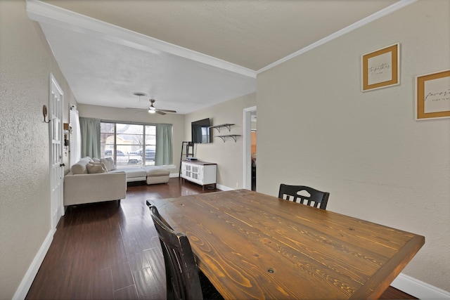 dining space with a textured wall, a ceiling fan, baseboards, dark wood finished floors, and crown molding