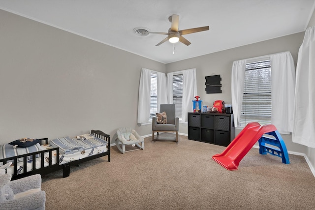 bedroom featuring carpet floors, multiple windows, and baseboards