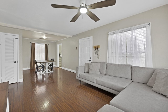 living room with a ceiling fan, dark wood-style flooring, and baseboards