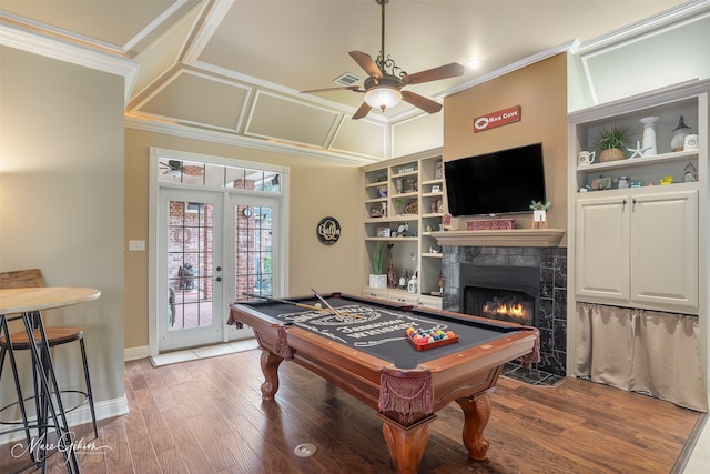 playroom with a fireplace, visible vents, ornamental molding, wood finished floors, and coffered ceiling