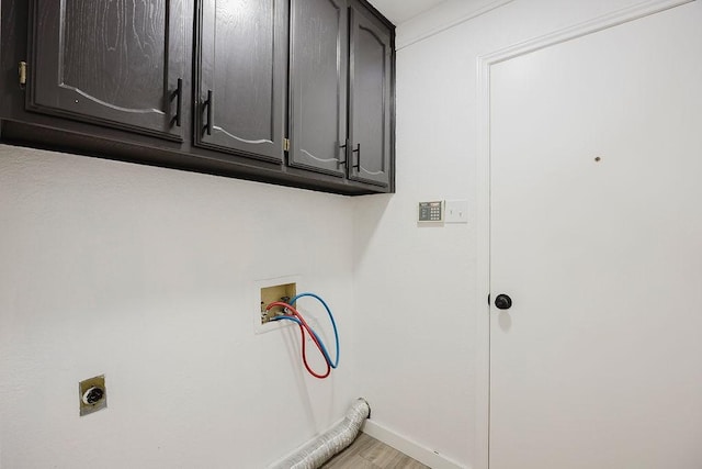 laundry room featuring washer hookup, light wood finished floors, cabinet space, electric dryer hookup, and baseboards